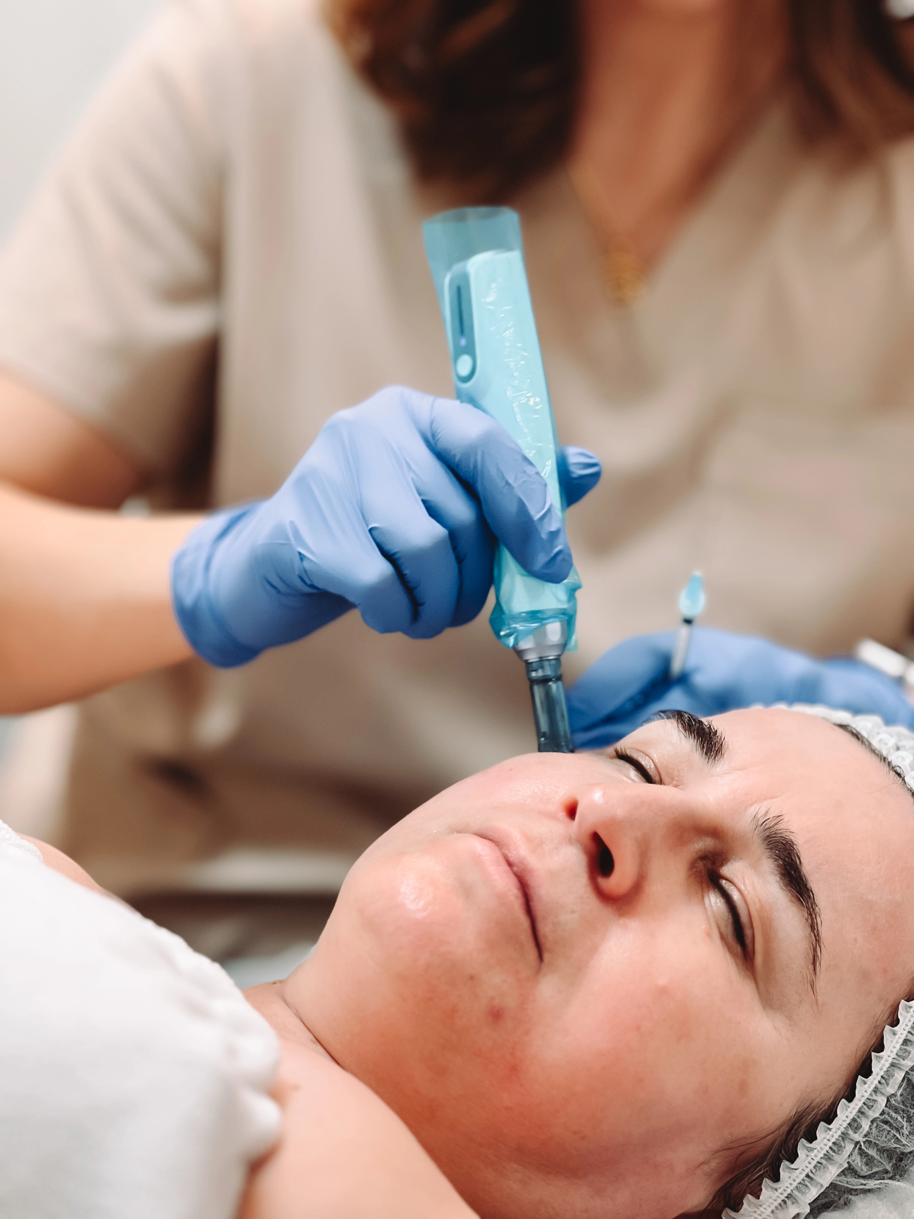 Client receiving a professional skin treatment at ZK Beauty Clinic using advanced skincare techniques.